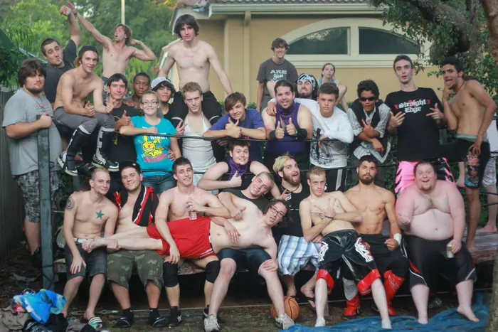 Large crew photo on and around a ring in a sunny yard